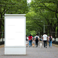 Empty white billboard in green park walkway with people