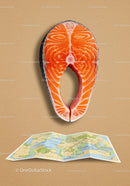Fresh salmon steak above unfolded world map on beige