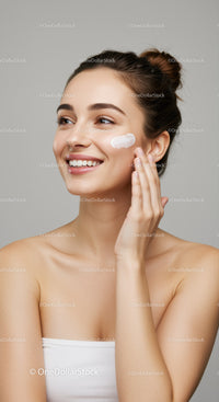 Young Woman Applying Skincare Cream for Healthy Glow