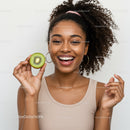 Vibrant Smiling Woman Holding Fresh Kiwi for Healthy Lifestyle