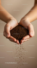Hands gently holding and pouring loose coffee granules