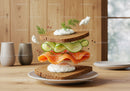Fresh salmon and cucumber sandwich with creamy dill sauce