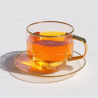Elegant Clear Glass Tea Cup with Amber Liquid for Refreshing Drinks