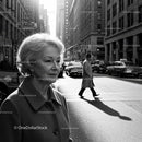 Elderly Woman in Busy City Street Surrounded by Vintage Cars
