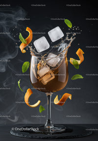 Refreshing cocktail splash with ice and citrus zest