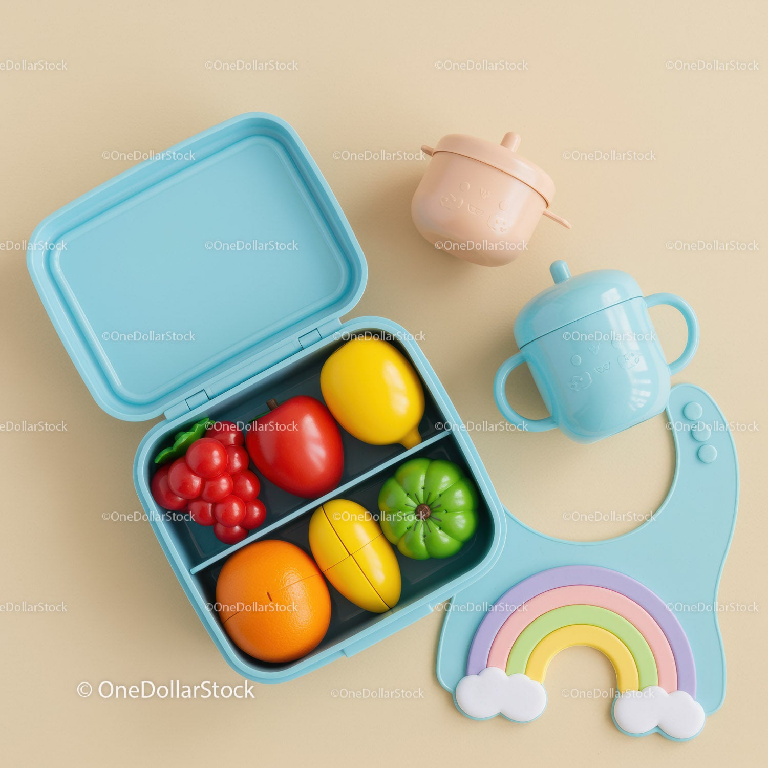 Colorful baby feeding set with toy fruits and rainbow bib