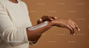 Woman Applying Sunscreen Lotion on Arm for Sun Protection