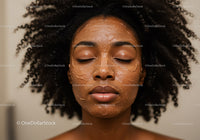 Elegant Black Woman with Afro Hair and Clay Facial Mask for Skin Rejuvenation