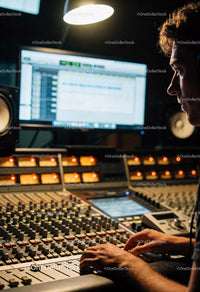 Sound engineer working with audio mixer and monitor