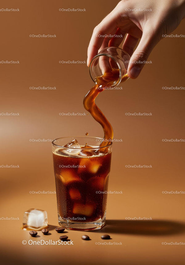 Pouring Cold Brew Coffee with Ice Cubes and Coffee Beans