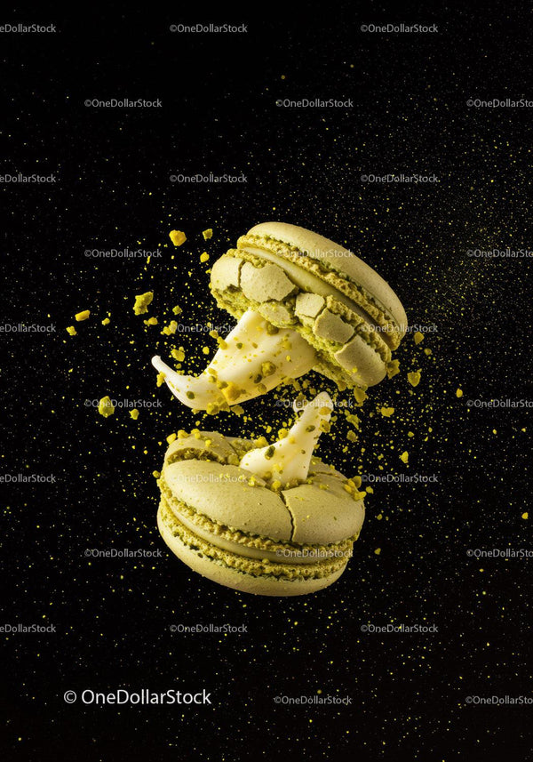 Green Macarons with Cream Filling Exploding on Black