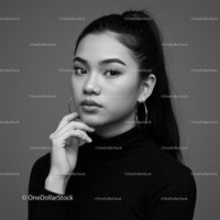 Elegant Black and White Portrait of a Young Woman with Hoop Earrings