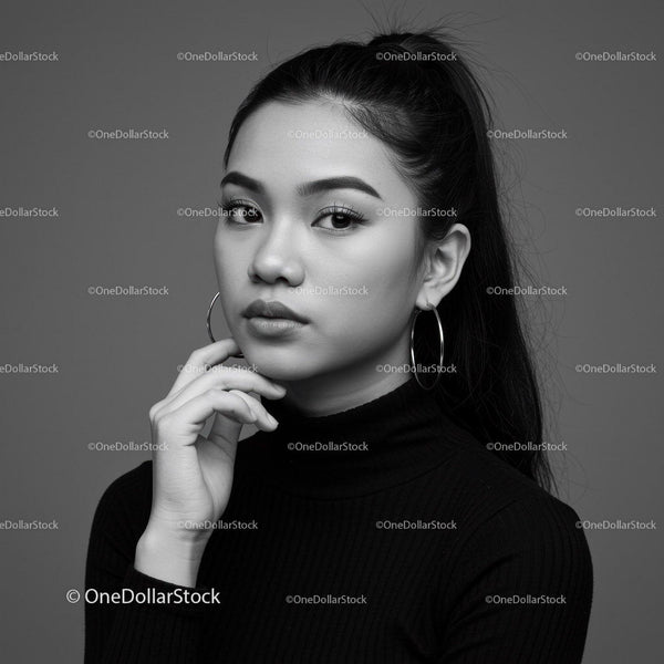 Elegant Black and White Portrait of a Young Woman with Hoop Earrings