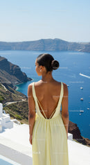 Woman in Yellow Dress Overlooking Blue Ocean View