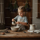 Little girl pouring water into bowl in rustic kitchen