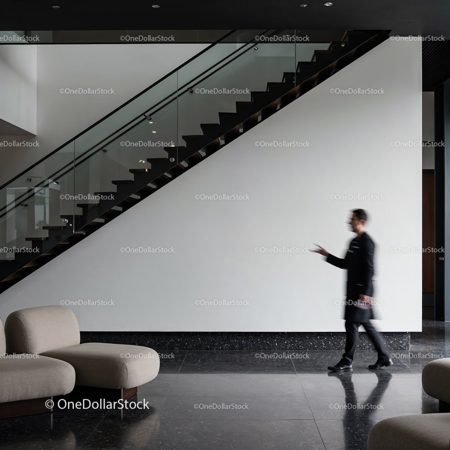 Blurred man walking past modern staircase in lobby