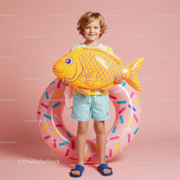 Smiling child with inflatable fish and donut float