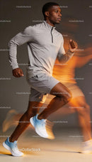 Focused young man running indoors in sportswear