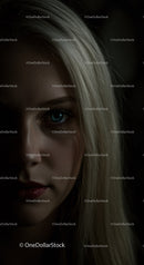 Close up portrait of woman with blue eyes in low light