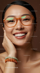 Smiling young woman with orange glasses and beaded bracelets
