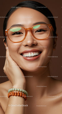 Smiling young woman with orange glasses and beaded bracelets