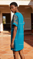 Young woman in blue dress with embroidered sleeves