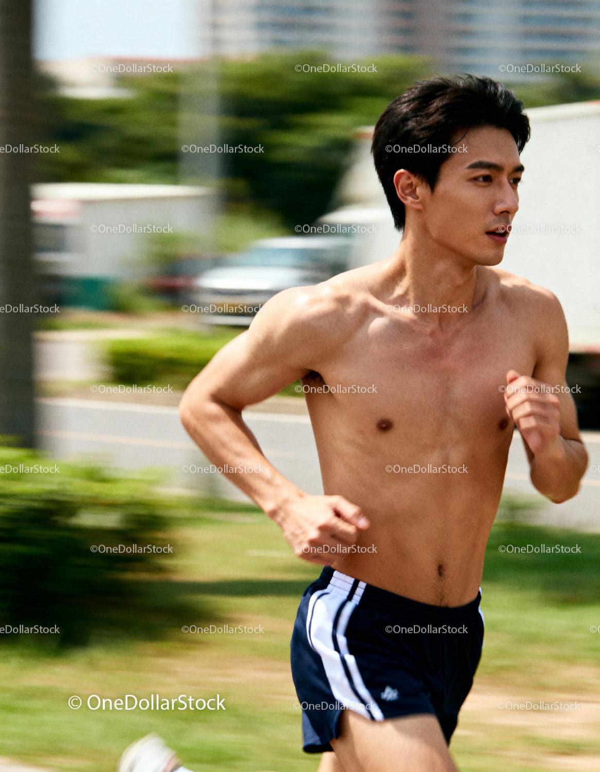 Athletic man running outdoors on a sunny day