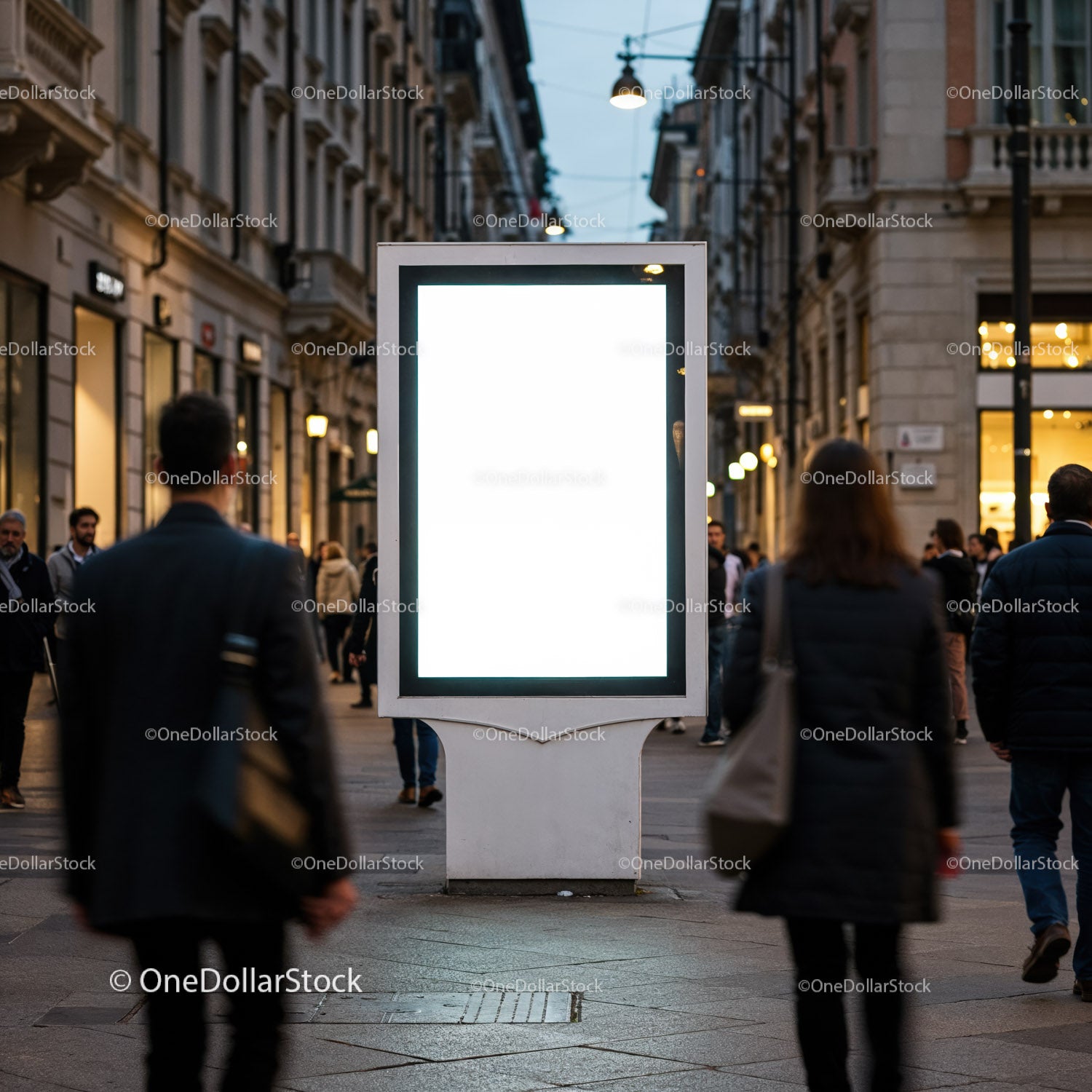 Blank illuminated billboard on busy urban street at dusk