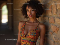 Elegant Woman with Curly Hair in Orange Dress and Jewelry