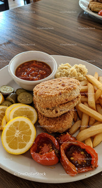Crispy chicken nuggets with fries and fresh sides