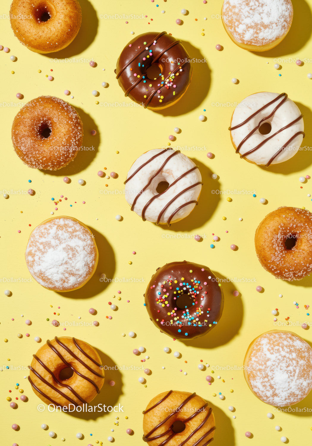 Assorted colorful donuts with sprinkles on yellow