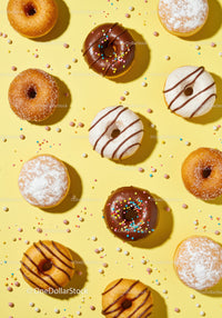Assorted colorful donuts with sprinkles on yellow
