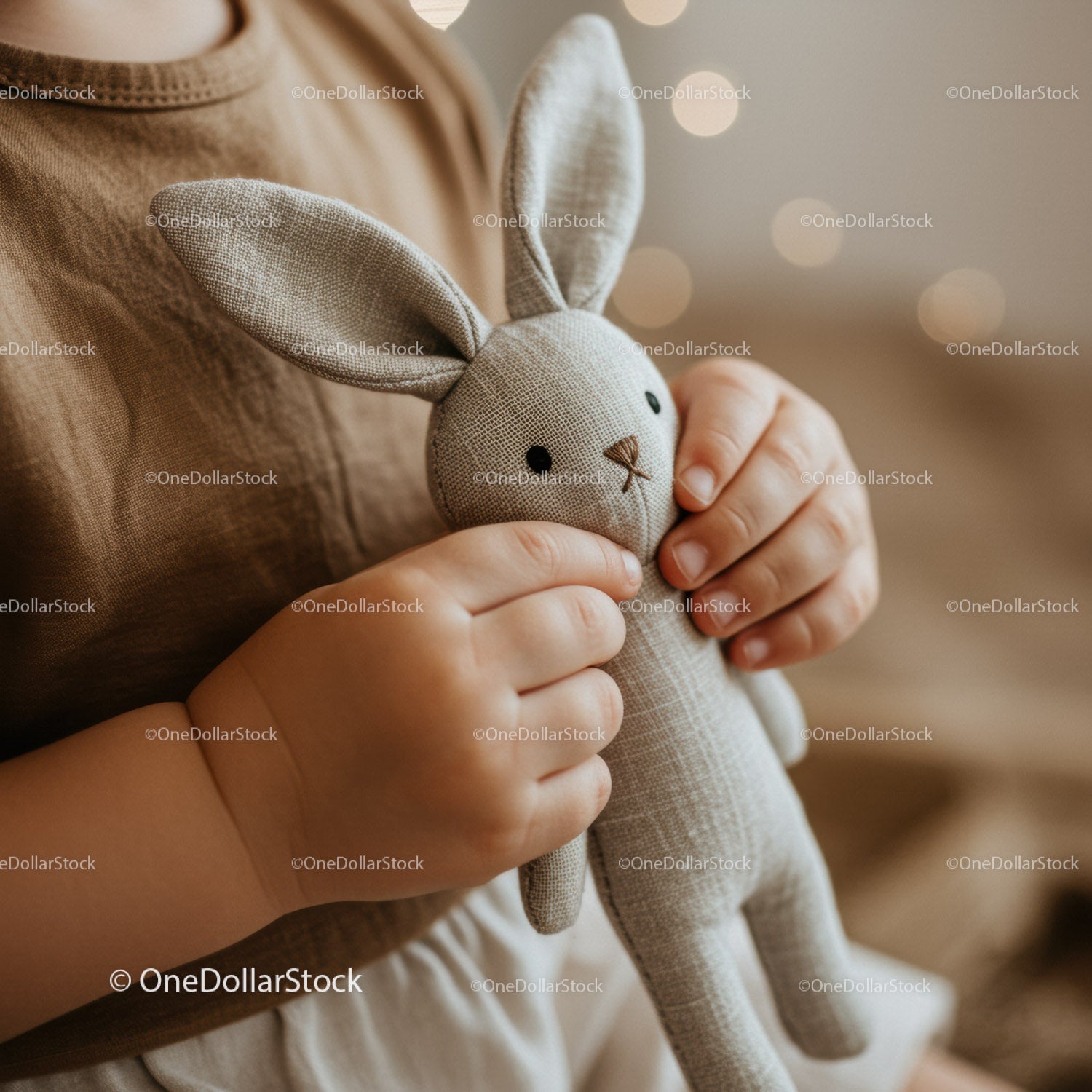 Child holding soft fabric bunny close up