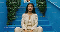 Chic Young Woman Sitting on Blue Stairs in Urban Environment