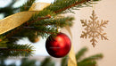 Festive close-up of Christmas tree ornaments and ribbon