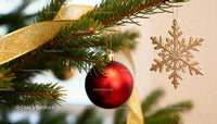 Festive close-up of Christmas tree ornaments and ribbon