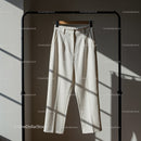 High Waist White Trousers Hanging on Minimalist Rack