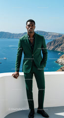 Young man in green suit standing by the sea cliff