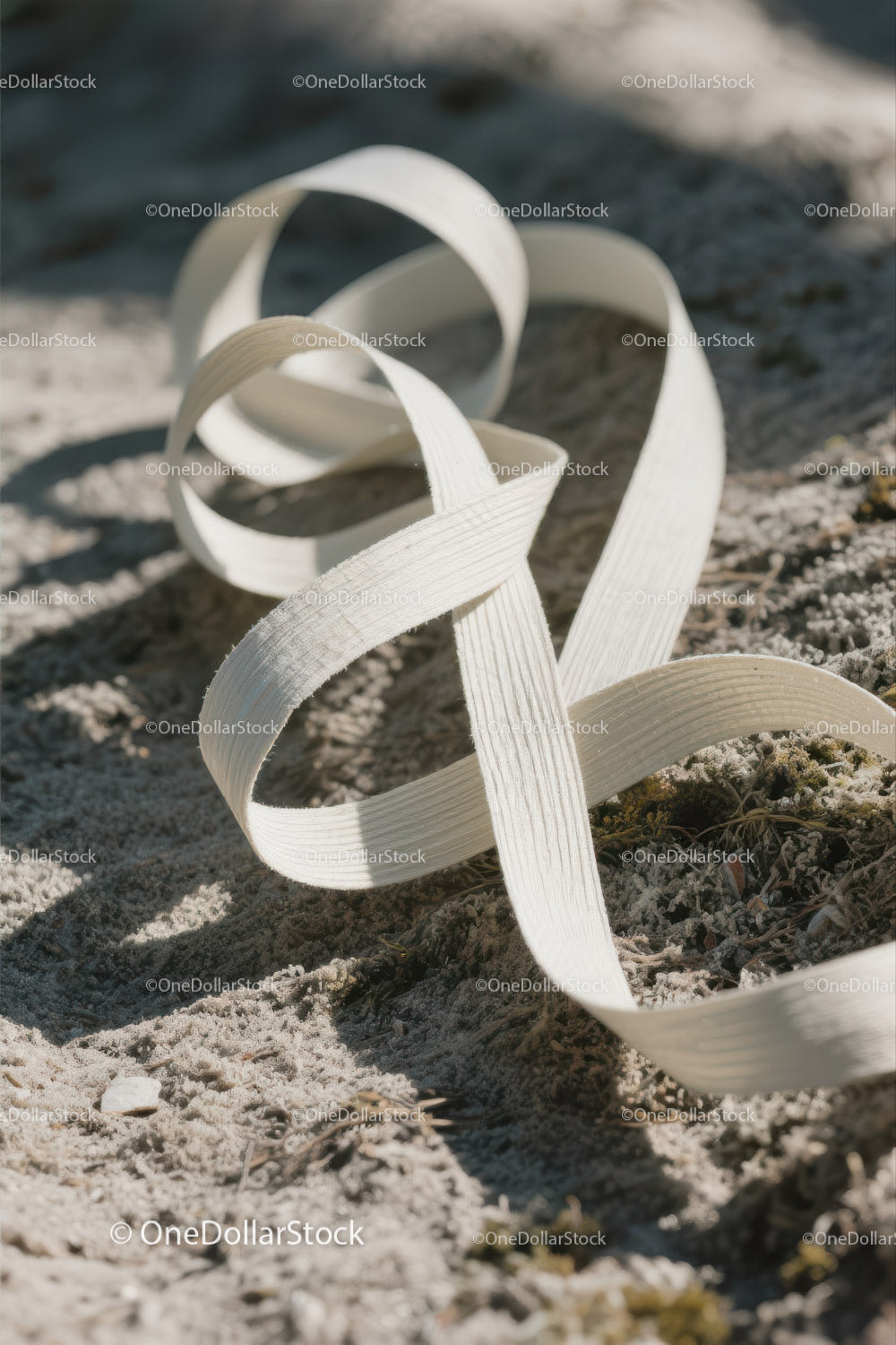 Close-up of White Plastic Ribbon Waste on Sandy Beach (23 Images)