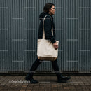 Man walking with canvas tote bag on urban street