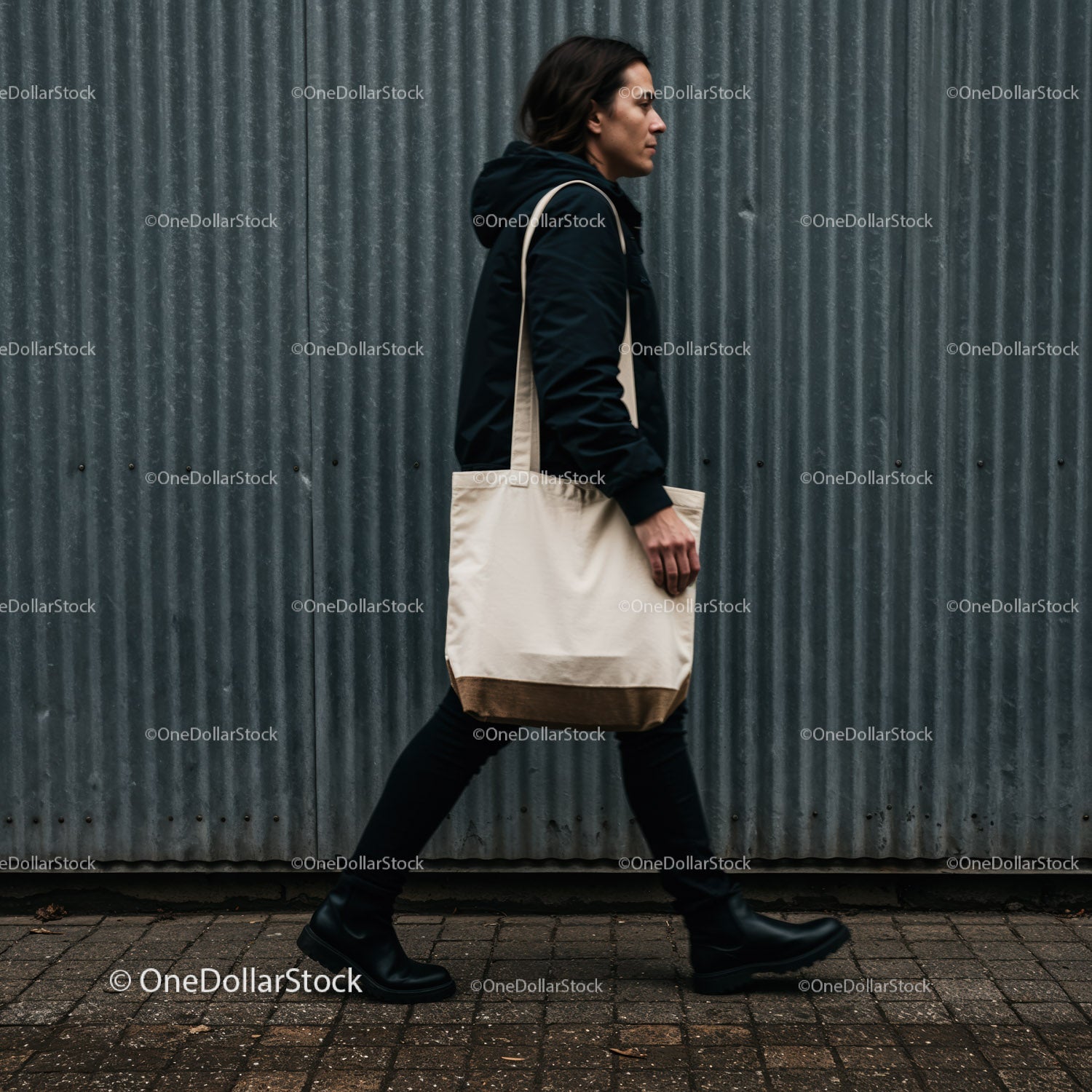 Man walking with canvas tote bag on urban street