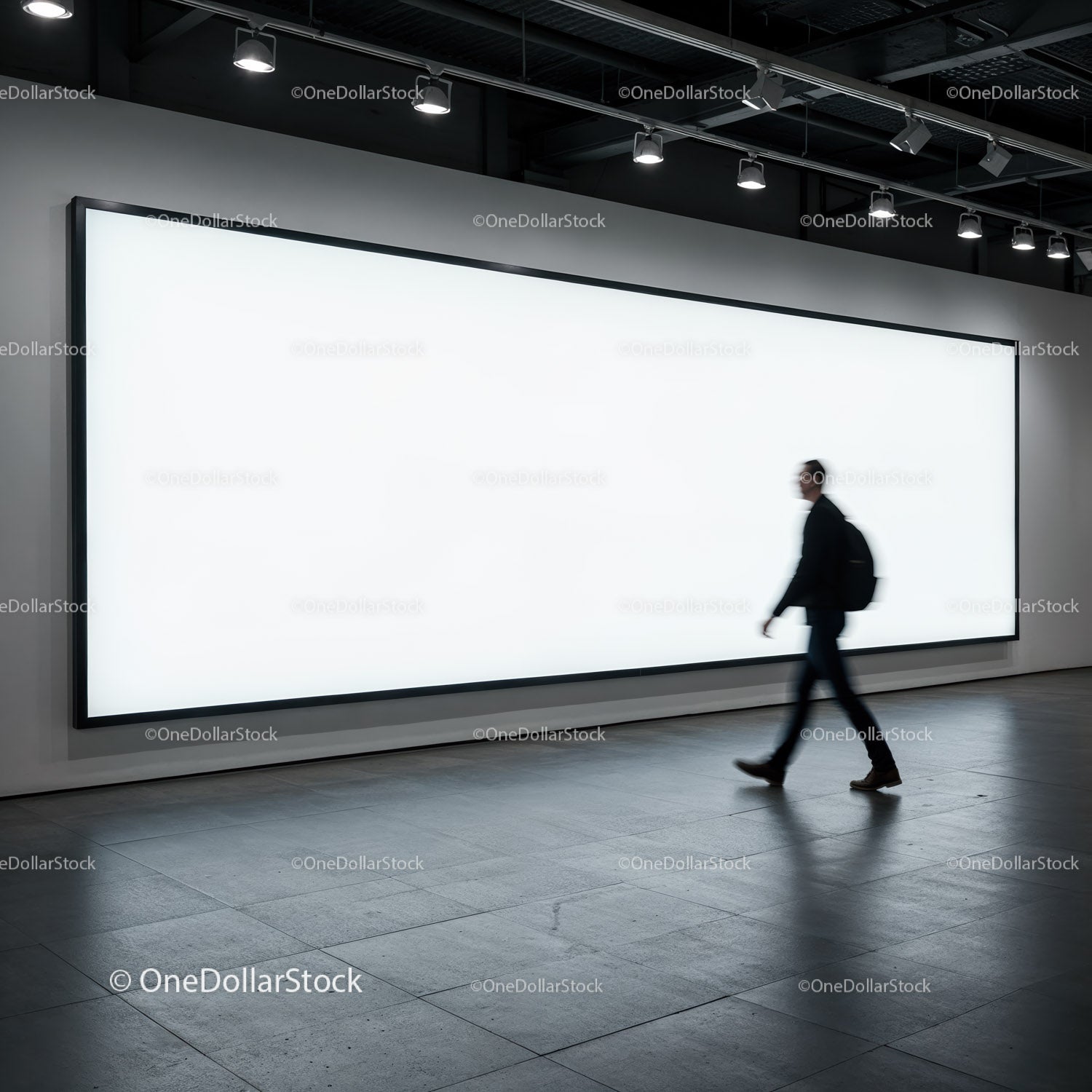 Man Walking Past Large Illuminated Blank Billboard Indoors