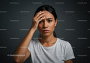 Frustrated Woman Holding Head with Hand in Indoor Studio