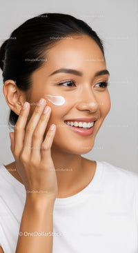 Young Woman Applying Facial Cream for Glowing Skin