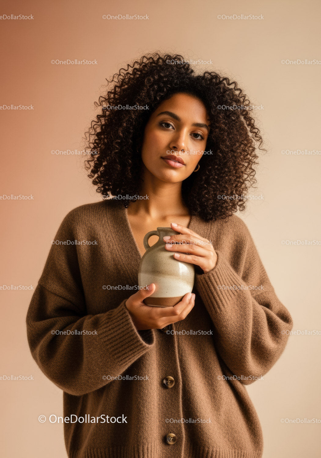 Elegant Woman with Curly Hair Holding Vase in Warm Indoor Setting