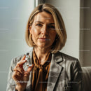 Confident Female Doctor Holding Medicine Vial in Clinical Setting