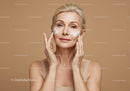 Mature Woman Applying Facial Cream for Skin Rejuvenation