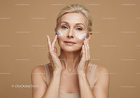 Mature Woman Applying Facial Cream for Skin Rejuvenation