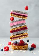 Healthy layered berry oat bars with fresh fruit topping