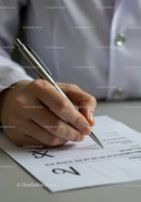 Doctor Writing Medical Prescription or Patient Report with Pen